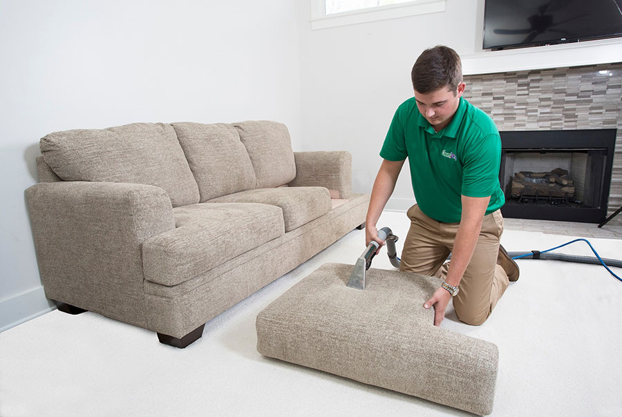 Chem Dry Employee Cleaning a Couch